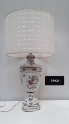 a lamp that is sitting on a table next to a lamp
