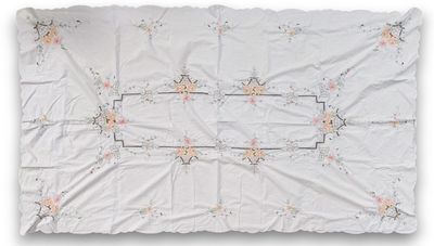 a white sheet with a floral design on it