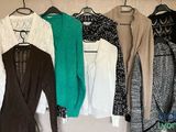 a lot of clothes hanging on a rack in a room