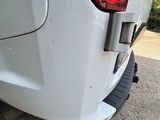 a close up of a white car with a red light on it
