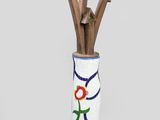 a vase that has a bunch of sticks in it