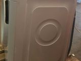 a white washing machine sitting on a pallet in a warehouse