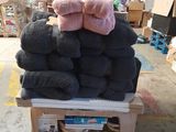 a pile of towels sitting on top of a cart in a warehouse