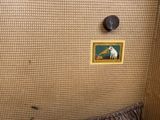 a picture of a cat sitting on a bed in a room