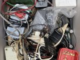a cardboard box filled with assorted electronics and wires