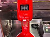 a red coffee maker sitting on a counter next to a toaster and a toaster