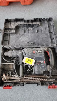a box with a drill and other tools on the floor