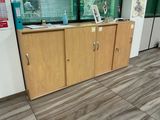 a wooden cabinet in the middle of a room