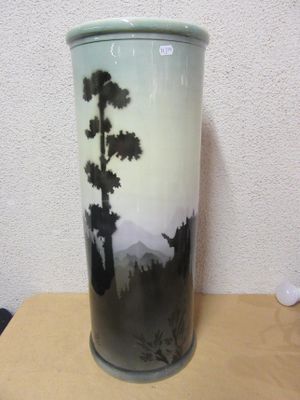 a vase that has a painting on it on a table