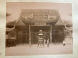 an old photo of a chinese building with people standing in front of it