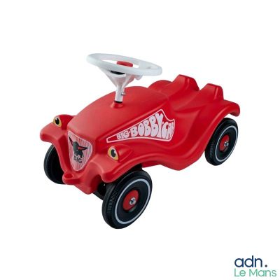 red toy car with a steering and a steering wheel on a white background