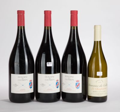 three bottles of wine are lined up on a white surface