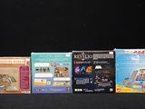 four nintendo wii games in a row on a black surface
