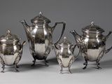 a group of five silverplated tea and coffee pots