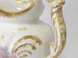 a white and gold vase with flowers on it
