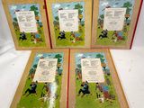 three children ' s books with pictures of dogs and people on them