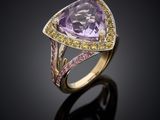 a yellow gold ring with an amethorate, pink sapphire and yellow diamonds