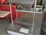 a metal shelf with a sign on it in a warehouse