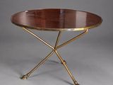a brass and wood coffee table with a circular top