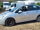 a picture of a small silver car parked in a lot