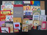 many children ' s books arranged on a black surface