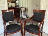 two chairs that are sitting in front of a table