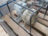 a pump that is sitting on a pallet in the yard