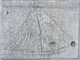 a stone plaque with a boat carved into it