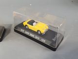 two toy cars that are sitting in a display case