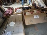 plusieurs cartons remplis d'objets dans un garage, avec un homme debout à côté