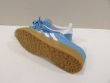 adidas gazelle blue and white sneakers with gum soles on a white surface