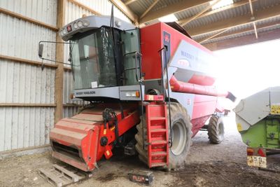 a large red combiner that is parked in a building