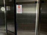 several stainless steel refrigerators are lined up in a row in a commercial kitchen