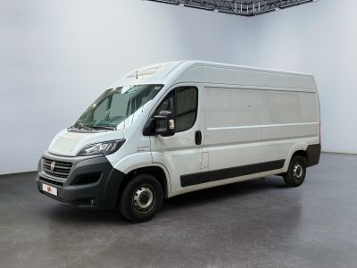 a picture of a white van parked in a large room