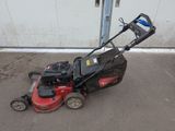 an image of a lawn mower parked in a parking lot