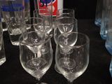 a lot of glasses and a can of pepsi on the table