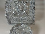 a clear glass object on a table with a white background