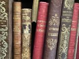 many old books that are on a shelf together