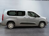 the silver van is parked in the garage with its door open