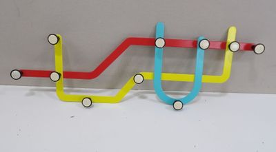 a multicolored coat rack on the wall