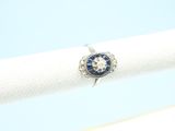 an image of a diamond and sapphire ring on a white napkin