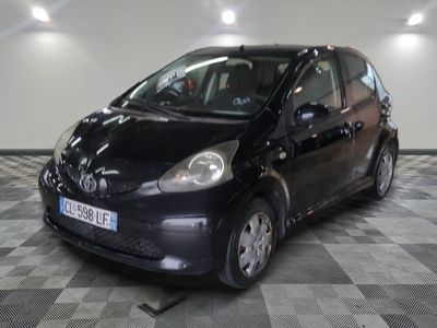 a picture of a small black car parked in a garage