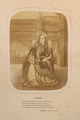 an old photograph of a woman in a regal dress sitting on a chair