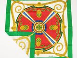 green, red, and gold square scarf with a design of a wheel of fortune