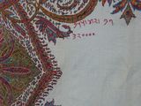 a close up of a paisley design on a white shirt
