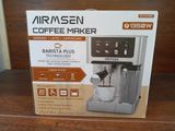 packaging of a coffee maker on a wooden shelf in a room