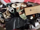 many pairs of shoes in a basket on the floor
