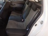 the back seats of a white car with a black seat belt