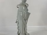 statue of a woman holding an umbrella in a white room