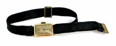 a watch that is on a black strap with a gold buckle